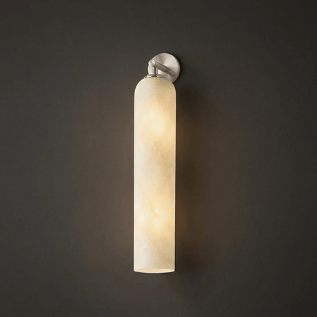The nickel version glowing warm against a dark gray wall