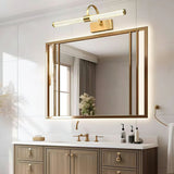 Brass arch and tube lit above a gilt framed mirror over a pale double vanity