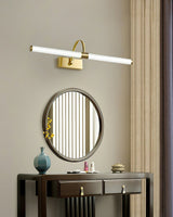 Brass arch and tube lit above a fluted oval mirror over a dark console table
