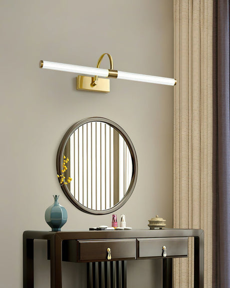 Brass arch and tube lit above a fluted oval mirror over a dark console table