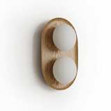 The wood capsule at an angle showing how the globes sit proud of the face