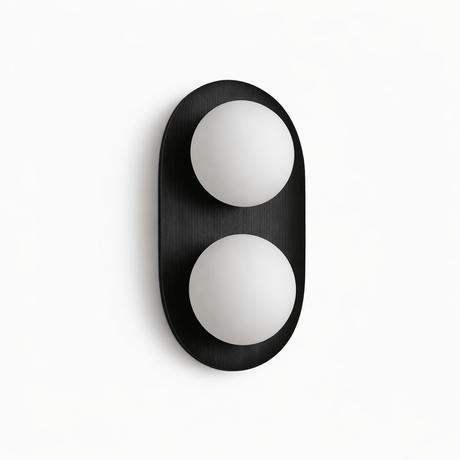 Black capsule with two opal globes set into its face, seen unlit