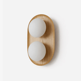 Two light wall sconce, a wood capsule holding two opal glass globes
