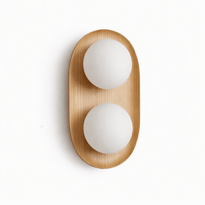 Light wood capsule with two opal globes set into its face, seen unlit