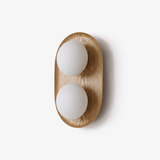 The smaller wood capsule with two opal globes stacked one over the other
