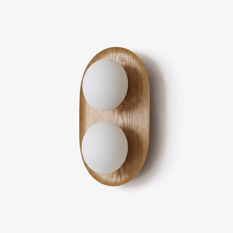 The smaller wood capsule with two opal globes stacked one over the other