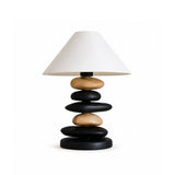 Unique table lamp with a light wood and matte black mixed stack
