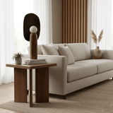 Totem table lamp on a square side table in a living room with a cream sofa