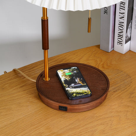Close view of a phone resting on the walnut base beside the brass pole