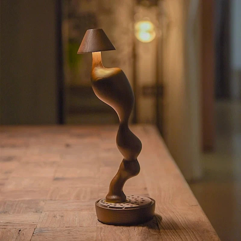 Cordless carved wood table lamp lit in a warm interior in the evening