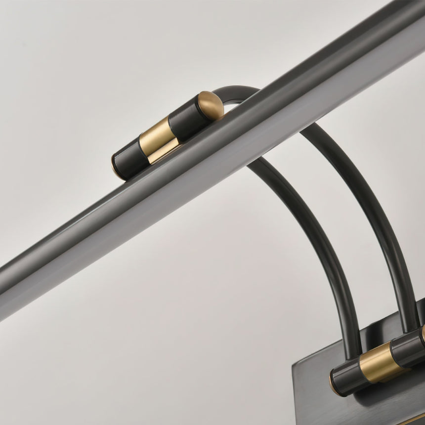 Close view of the dark bronze arms and the joint where they enter the wall plate