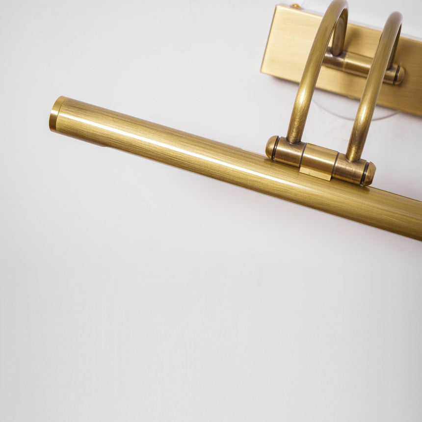 Close view of the brass tube end, the arched arms and the plate behind them
