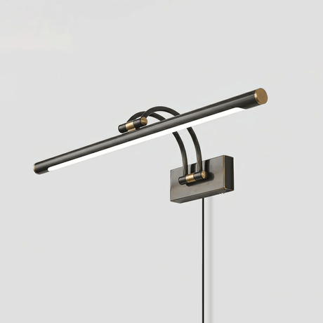 The dark bronze version seen at an angle with the cord dropping from the wall plate