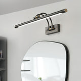 Dark bronze bar mounted above an irregular mirror on a white wall beside a cabinet