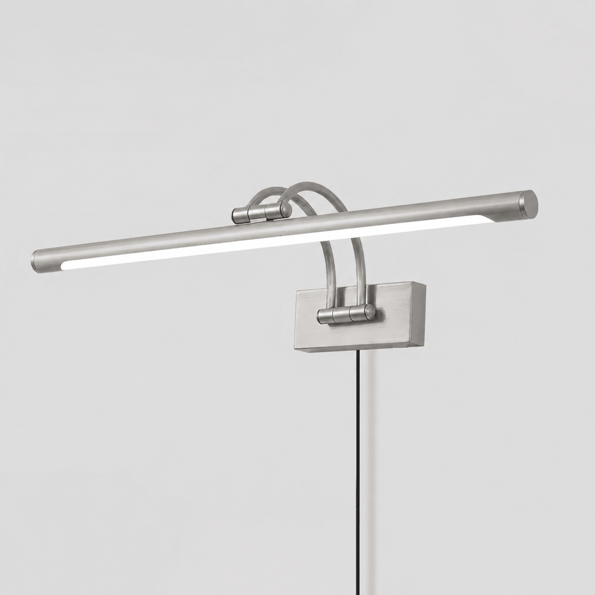 The nickel version seen at an angle, a pale tube on two arms with the cord hanging