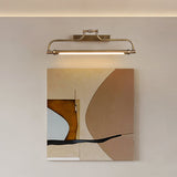 Bracket lit above a large framed abstract canvas on a pale plaster wall