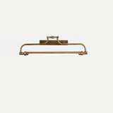 The bronze version seen straight on, a darker arch carrying the same tube