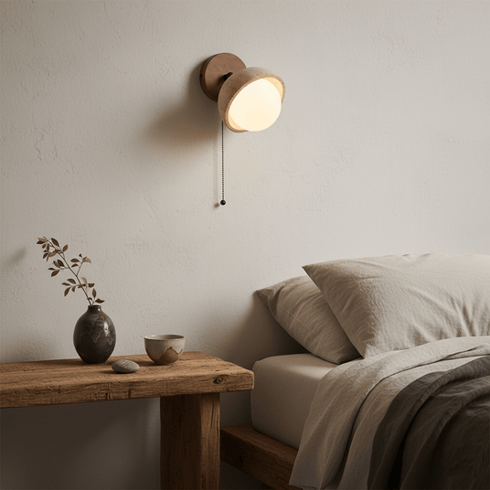 Single dome lit above a bench beside a bed with a stone vase on the bench