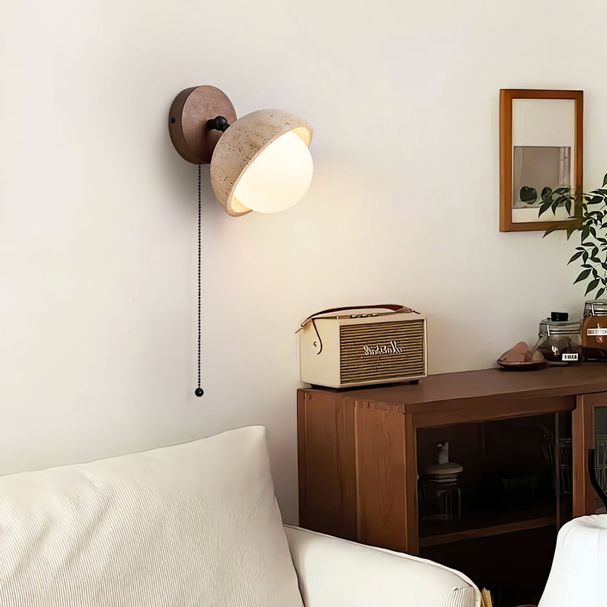 Single dome lit above a dresser holding a radio and a small framed print