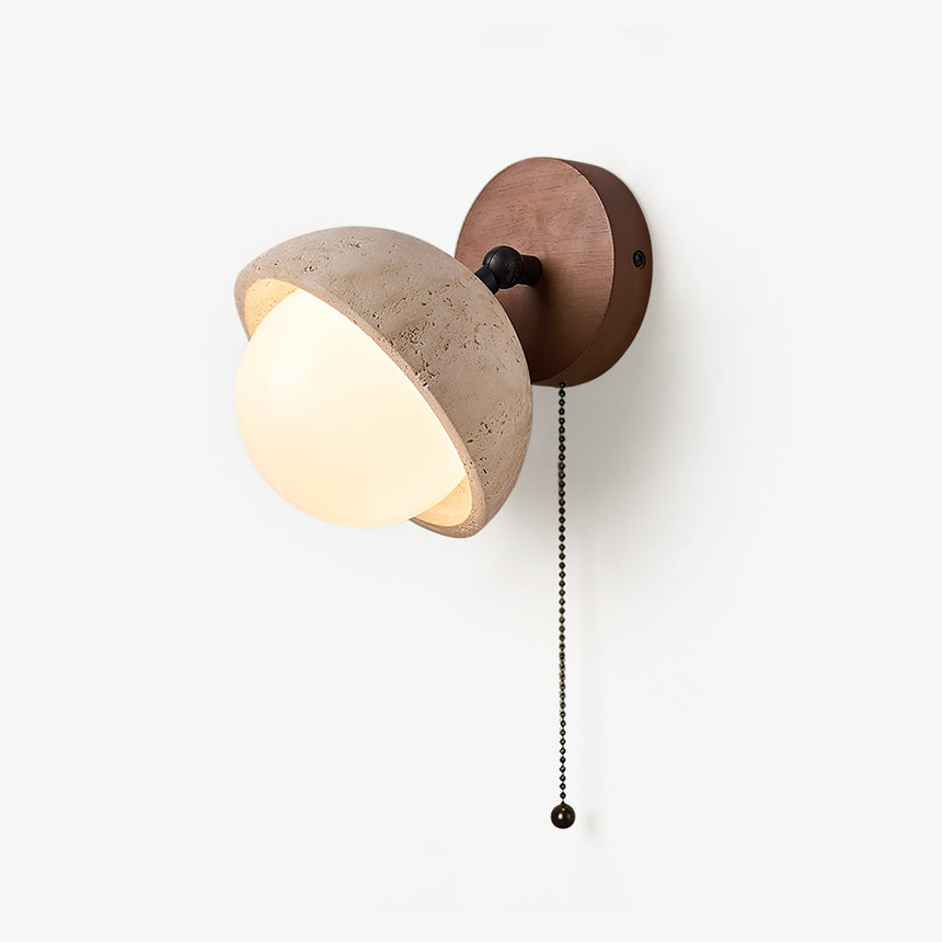 Vanity wall sconce, a travertine dome over a glass orb with a pull chain