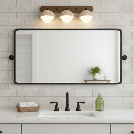 Three domes lit above a rectangular mirror on a tiled bathroom wall