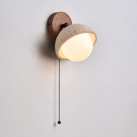 The single dome lit, the glass orb glowing under the porous stone shade