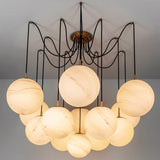 The same globes lit on black arms, spread wide below a round ceiling plate