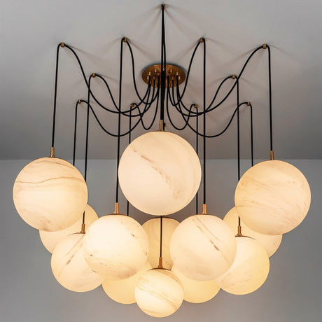 The same globes lit on black arms, spread wide below a round ceiling plate