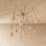 The globes unlit on brass arms, each stone sphere on its own curved stem