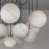 Alabaster globes unlit and clustered, each one held by a small brass fitting