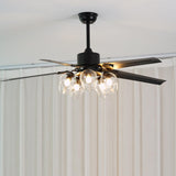 Black ceiling fan seen from below with the globe lights on