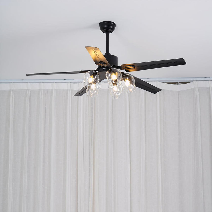 Black ceiling fan with glass globes near a curtained window