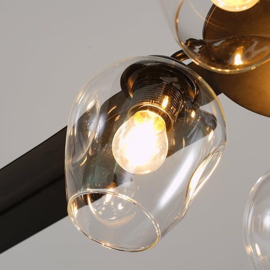 Close view of one clear glass globe and its filament bulb