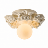 Carved floral ceiling light in white finish seen at an angle
