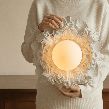 Carved floral ceiling light held in two hands to show its scale