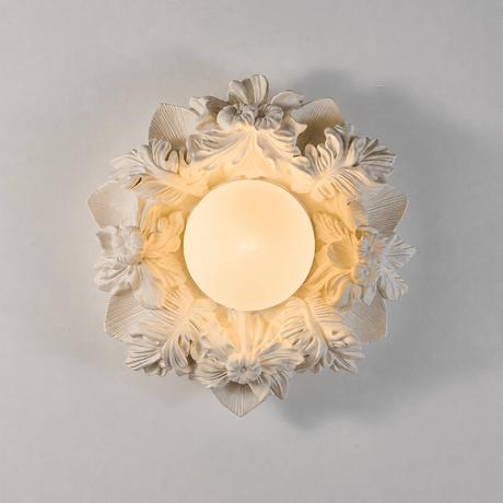 Carved floral ceiling light seen straight on with the petals lit from behind