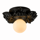 Matte black carved floral ceiling light with a white opal globe