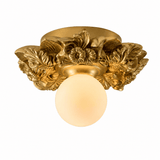 Gilded gold carved floral ceiling light seen from the side