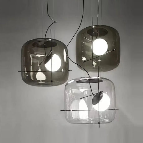 Three glass drum pendants of different tints hung as a group