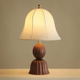 Close view of the bell shade and the two part fluted walnut base