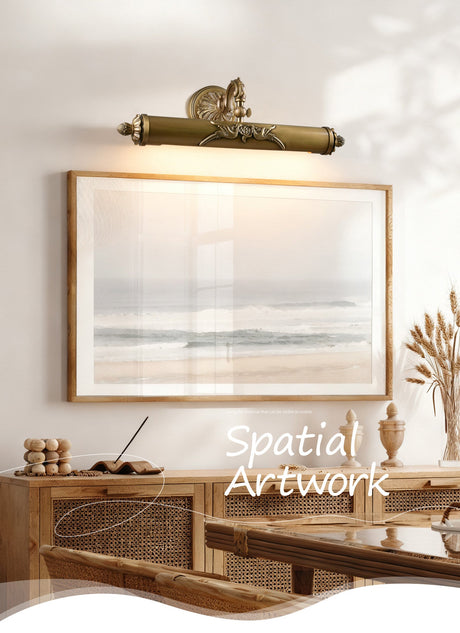 Scrolled brass bar lit over a framed canvas above a console in warm light
