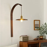 Lamp lit above a wood console with a mirror, a plant and small boxes