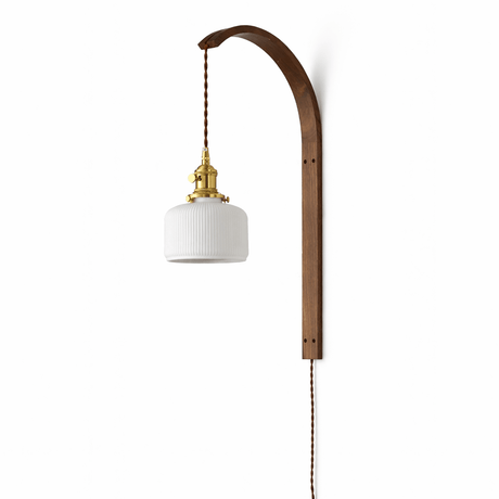 Small white glass drum shade hanging from the curved wood hook arm