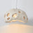 Cream perforated dome shade photographed against a pale ground