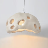 Cream perforated dome shade photographed against a pale ground
