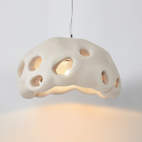 Cream perforated dome shade photographed against a pale ground