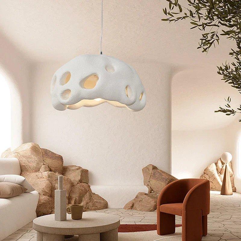 White perforated dome in a pale living room with stone furniture