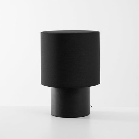 Wabi sabi table lamp in black seen from the front, plain ground