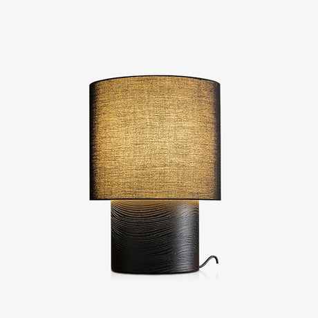 Wabi sabi table lamp in black with a dark shade, lit and plain