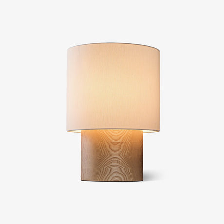 Wabi sabi table lamp with a cloth drum shade on a brushed wood plinth